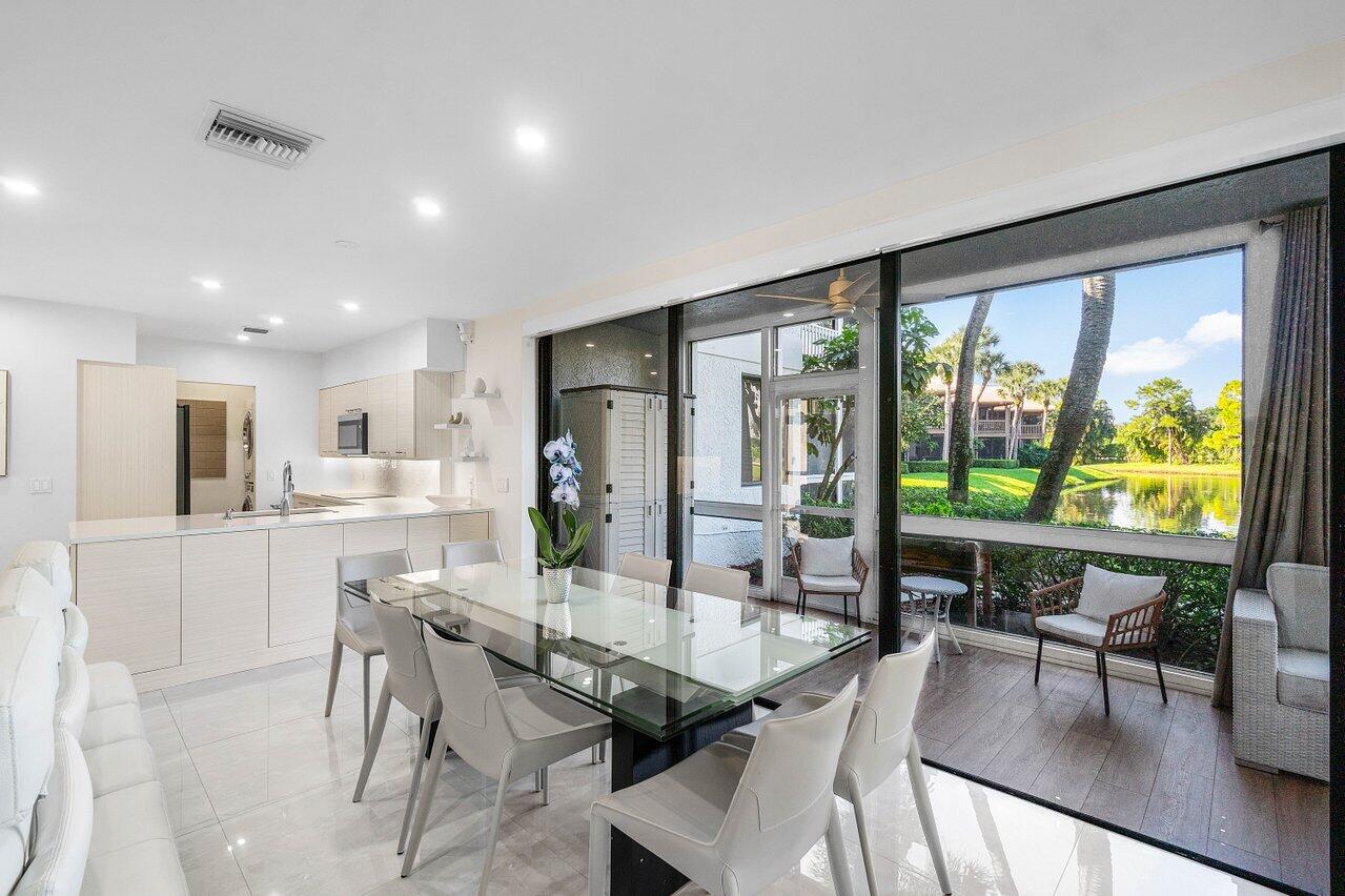 19173 Sabal Lake Drive, Unit 5155 Boca Raton, FL 33434 - Photo 8 of 33 a dining room with furniture and large windows