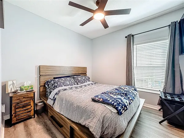 a bedroom with a bed and a chandelier