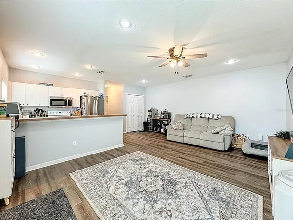 a living room with furniture and kitchen view