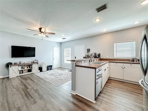 a kitchen with sink stove and refrigerator