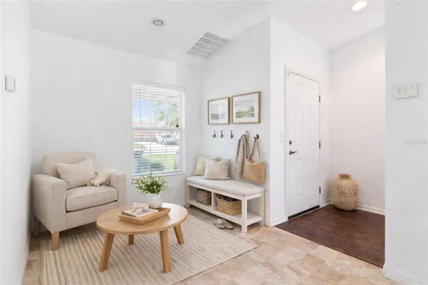 a living room with furniture and wooden floor