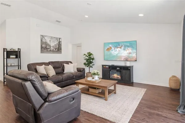 a living room with furniture and a fireplace