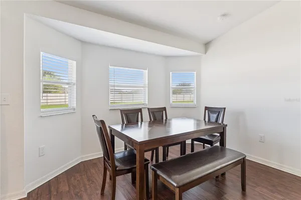 a view of a dining room with furniture and wooden floor