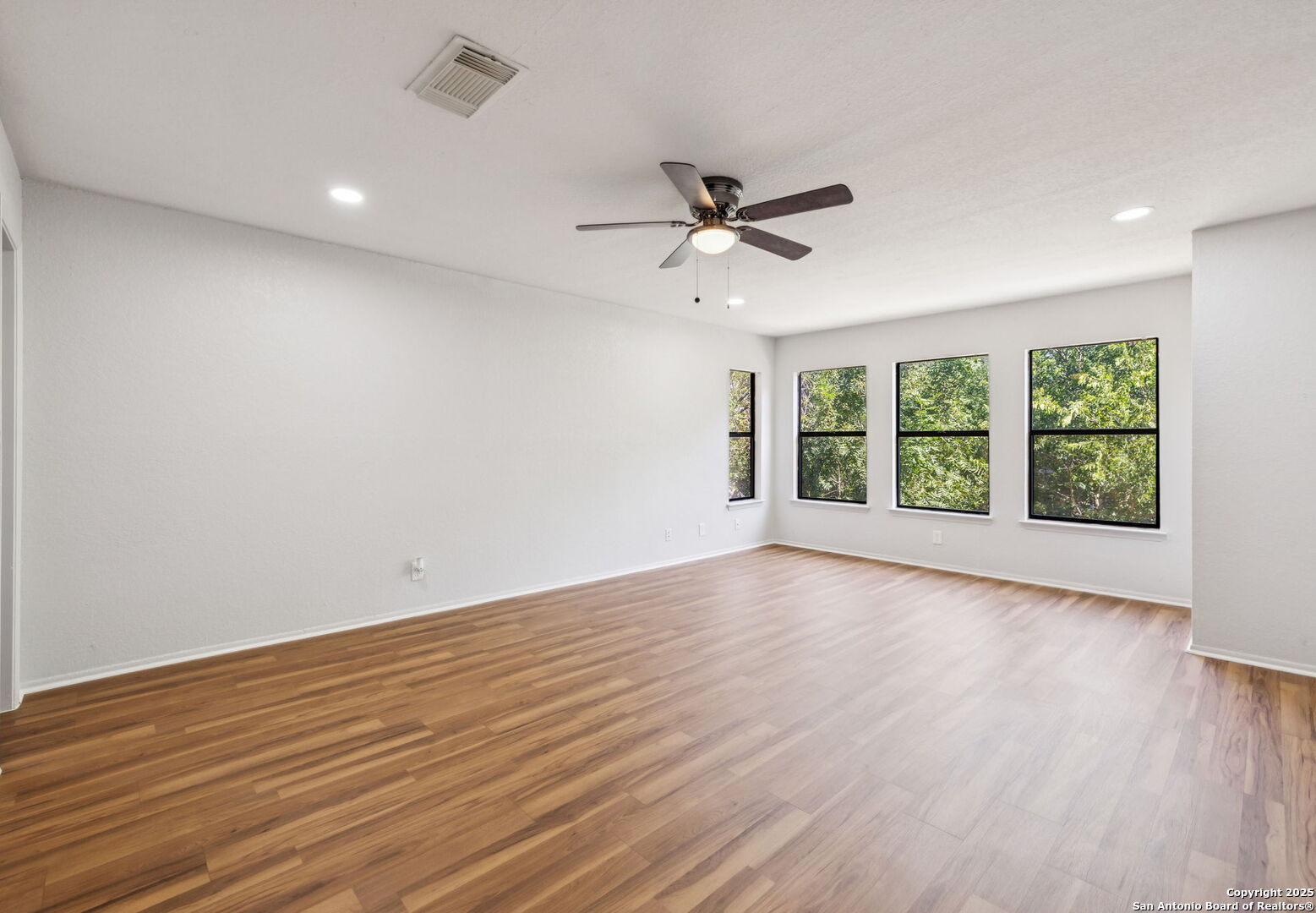 8127 Talkenhorn Converse, TX 78109 - Photo 18 of 57 wooden floor in an empty room with a window