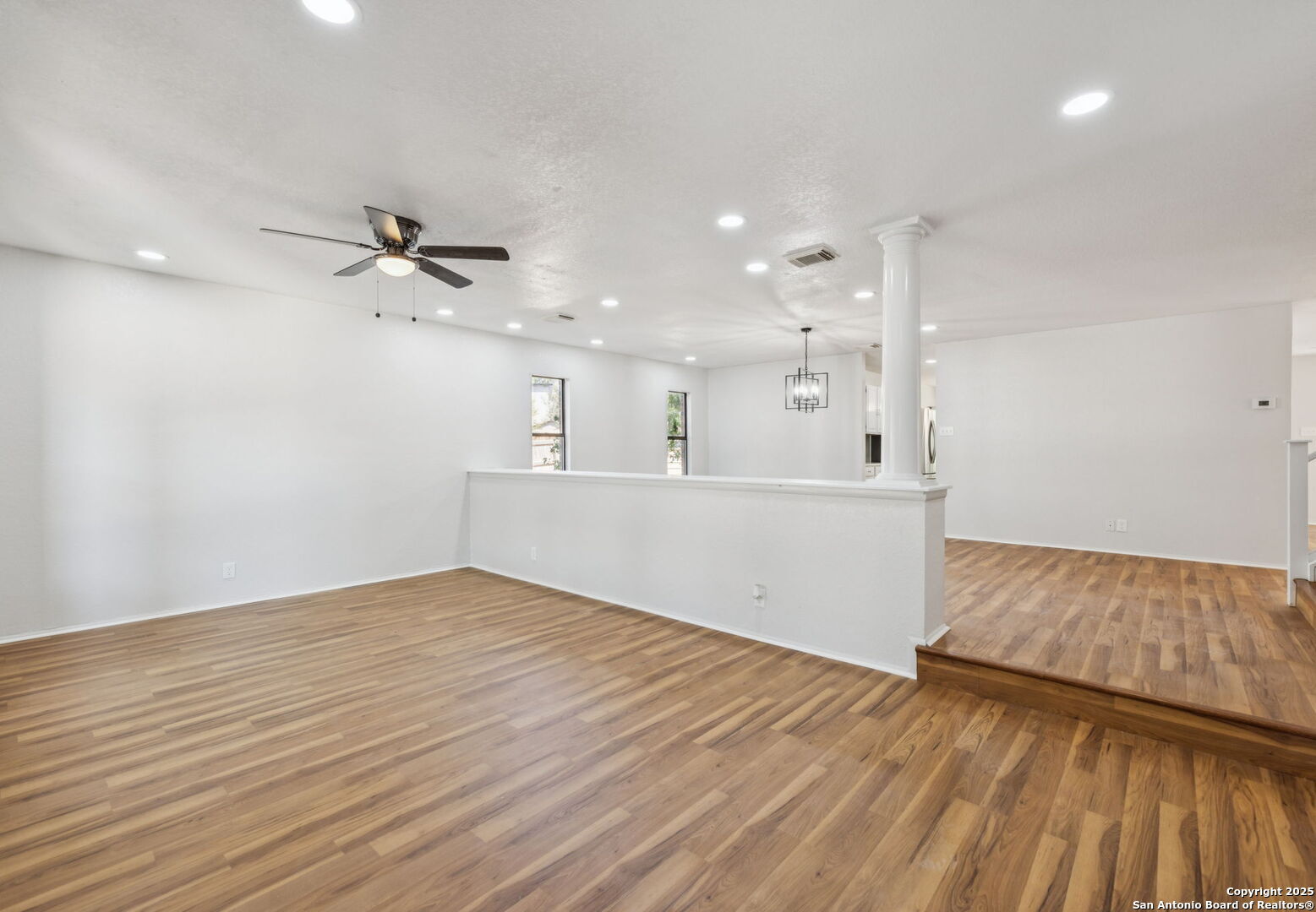 8127 Talkenhorn Converse, TX 78109 - Photo 20 of 57 a view of an empty room with wooden floor and a ceiling fan