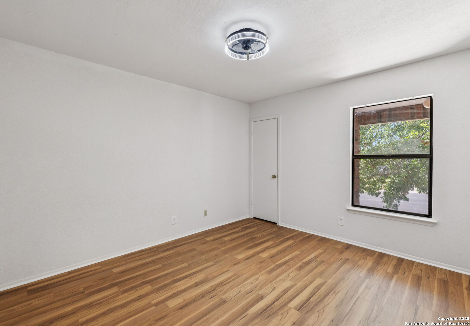 8127 Talkenhorn Converse, TX 78109 - Photo 26 of 57 a view of empty room with wooden floor and fan
