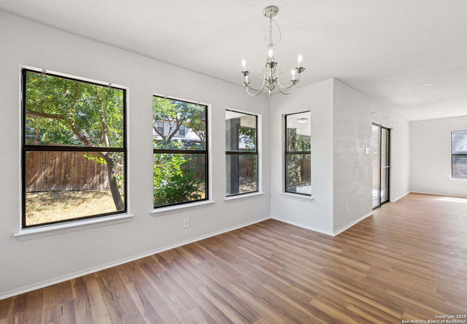 8127 Talkenhorn Converse, TX 78109 - Photo 29 of 57 a view of an empty room with wooden floor and a window