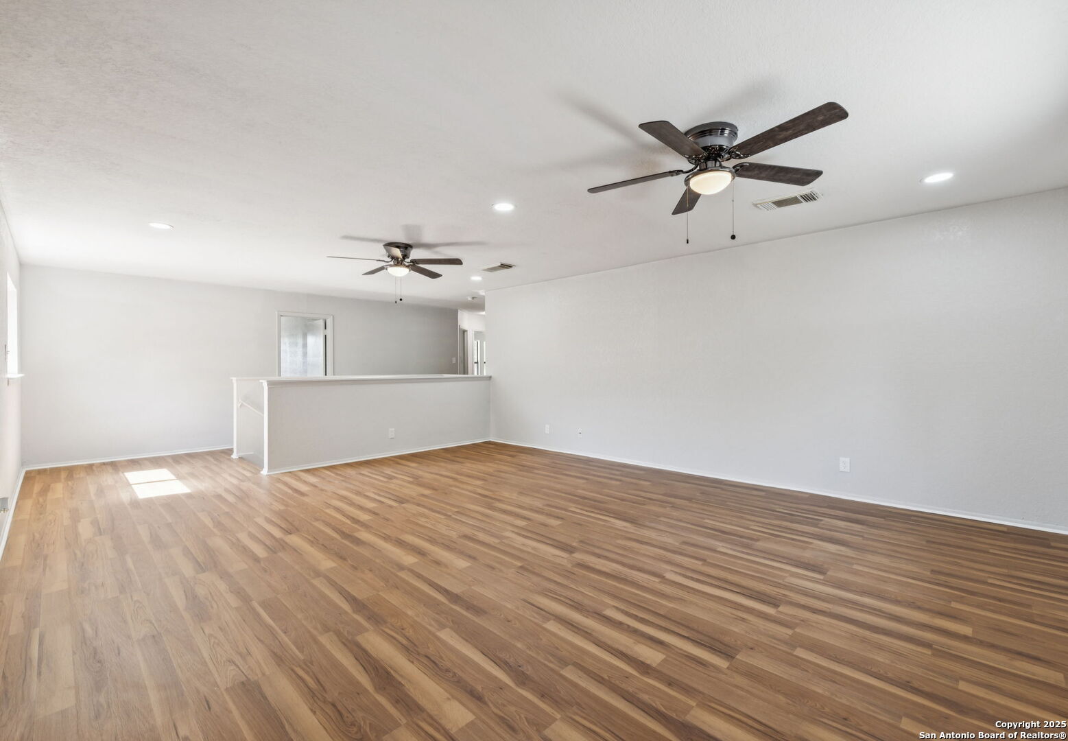 8127 Talkenhorn Converse, TX 78109 - Photo 30 of 57 a view of a livingroom with a ceiling fan wooden floor and window