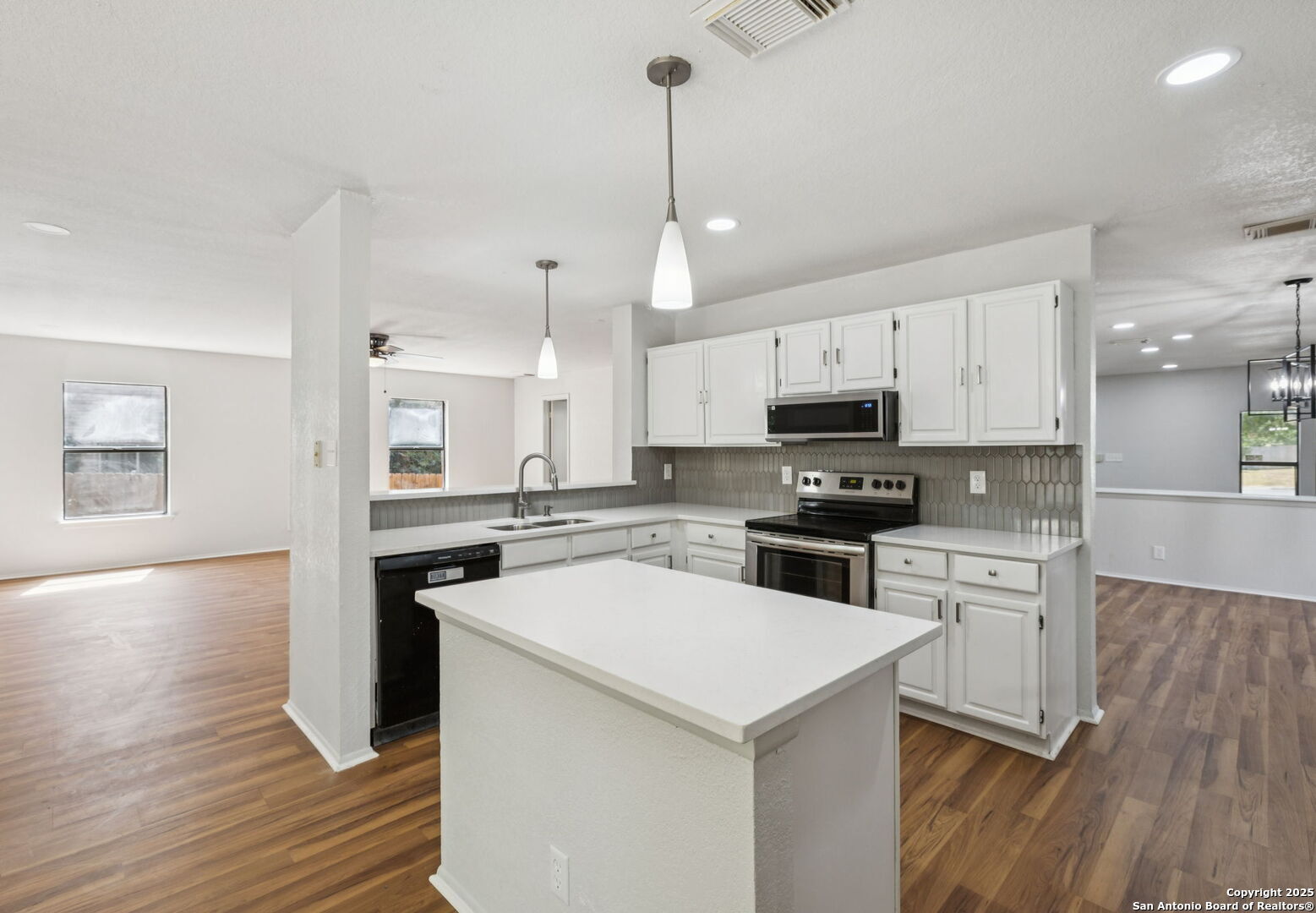8127 Talkenhorn Converse, TX 78109 - Photo 32 of 57 a kitchen with a sink a counter top space stainless steel appliances and cabinets