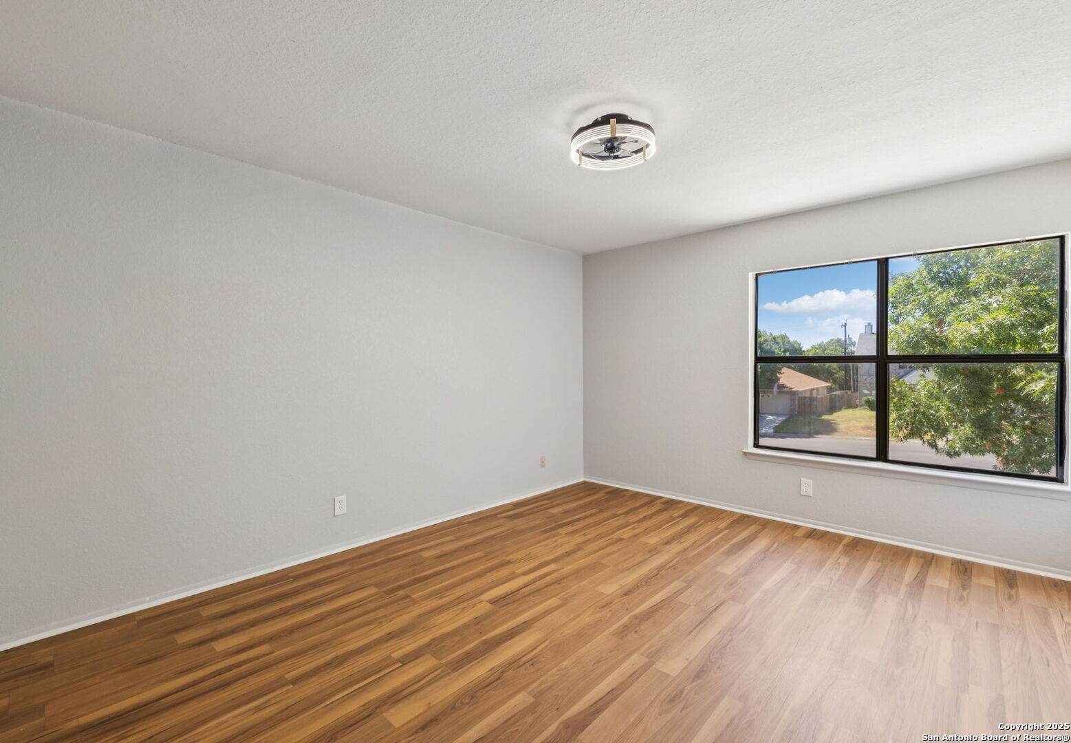 8127 Talkenhorn Converse, TX 78109 - Photo 39 of 57 wooden floor in an empty room with a window