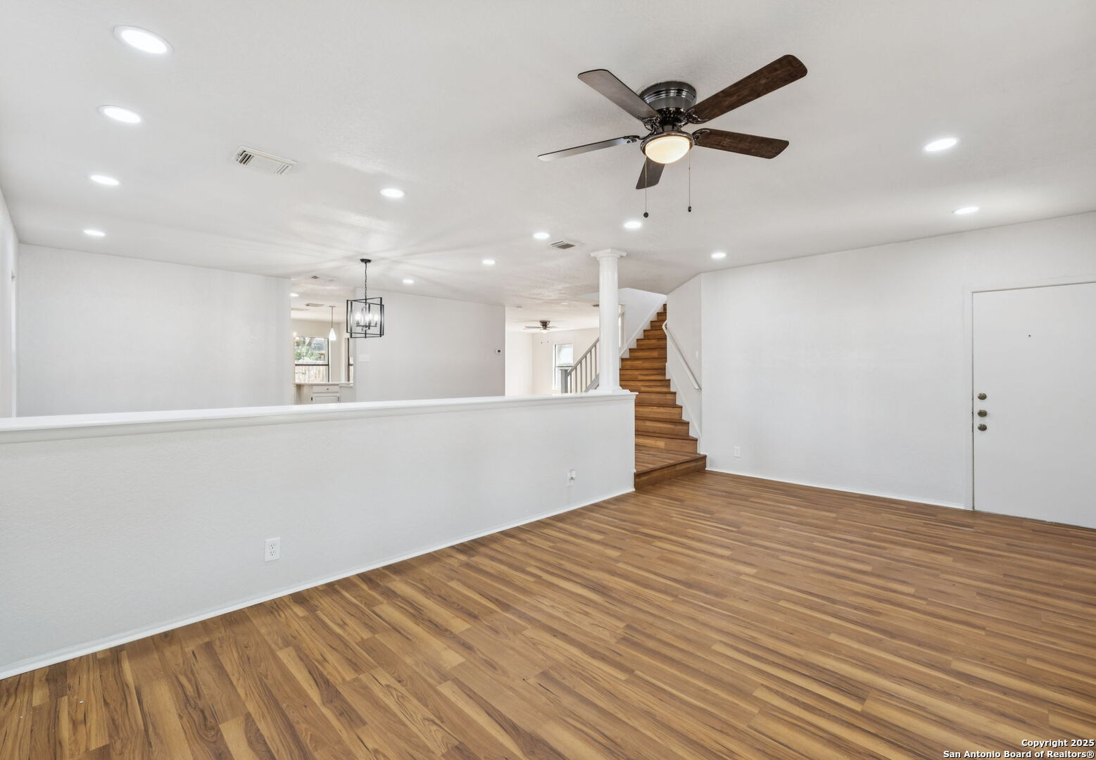 8127 Talkenhorn Converse, TX 78109 - Photo 45 of 57 an empty room with wooden floor and a ceiling fan