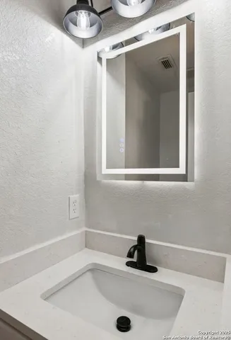 an aerial view of residential houses with outdoor space and ocean view