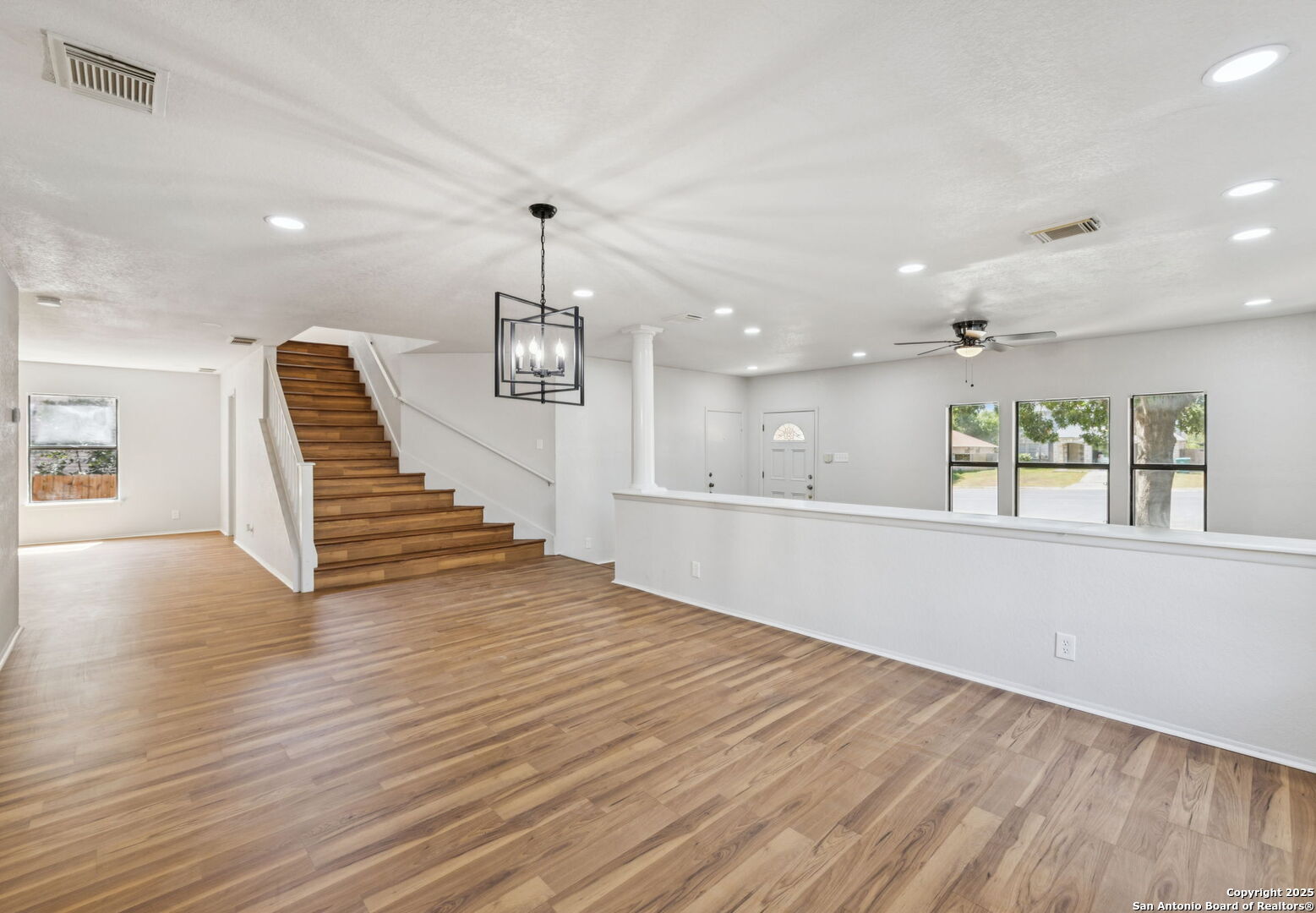 8127 Talkenhorn Converse, TX 78109 - Photo 9 of 57 a view of an empty room with wooden floor and a window