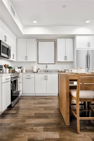 a kitchen with a white cabinets and white appliances