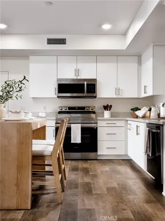 a kitchen with a stove a sink and a refrigerator