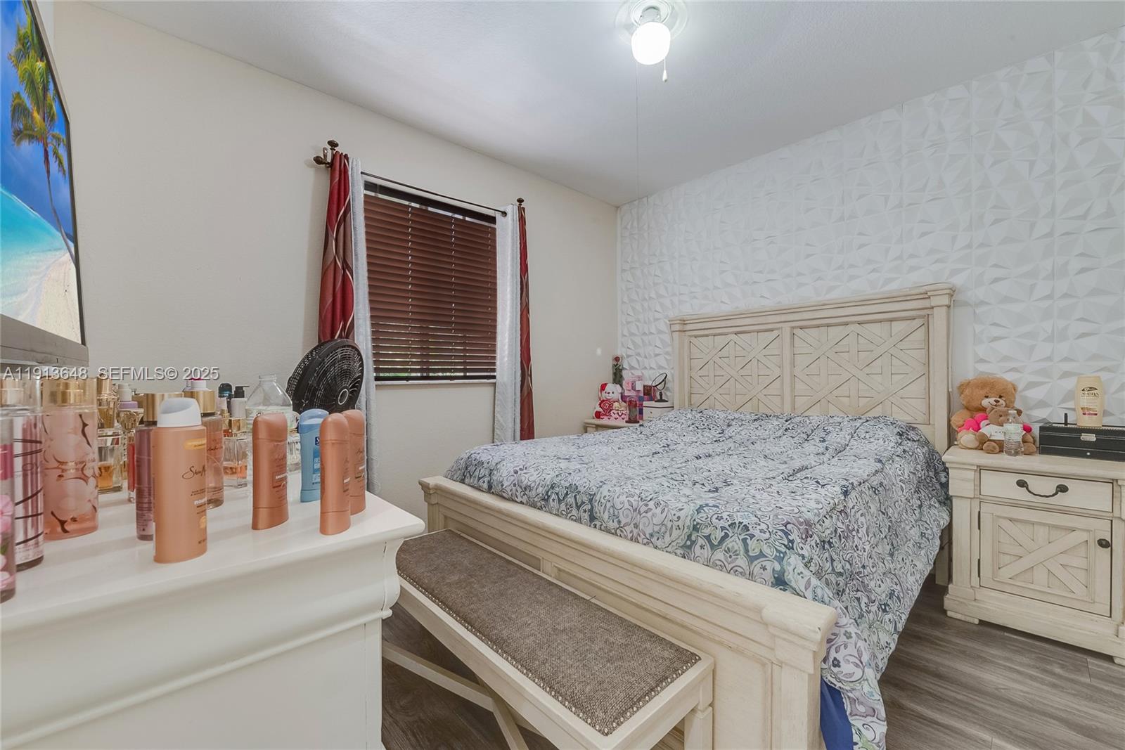 21441 Southwest 85th Path Cutler Bay, FL 33189 - Photo 11 of 17 a bedroom with a bed and dresser with wooden floor