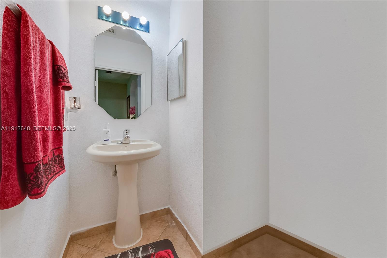 21441 Southwest 85th Path Cutler Bay, FL 33189 - Photo 17 of 17 a bathroom with a sink and mirror