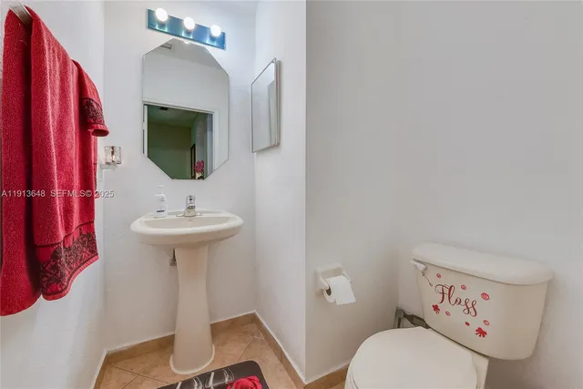 a bathroom with a sink toilet and mirror