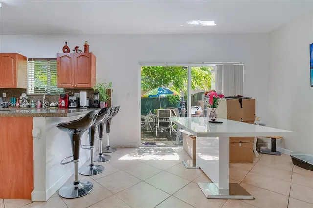 a kitchen with a table and chairs in it