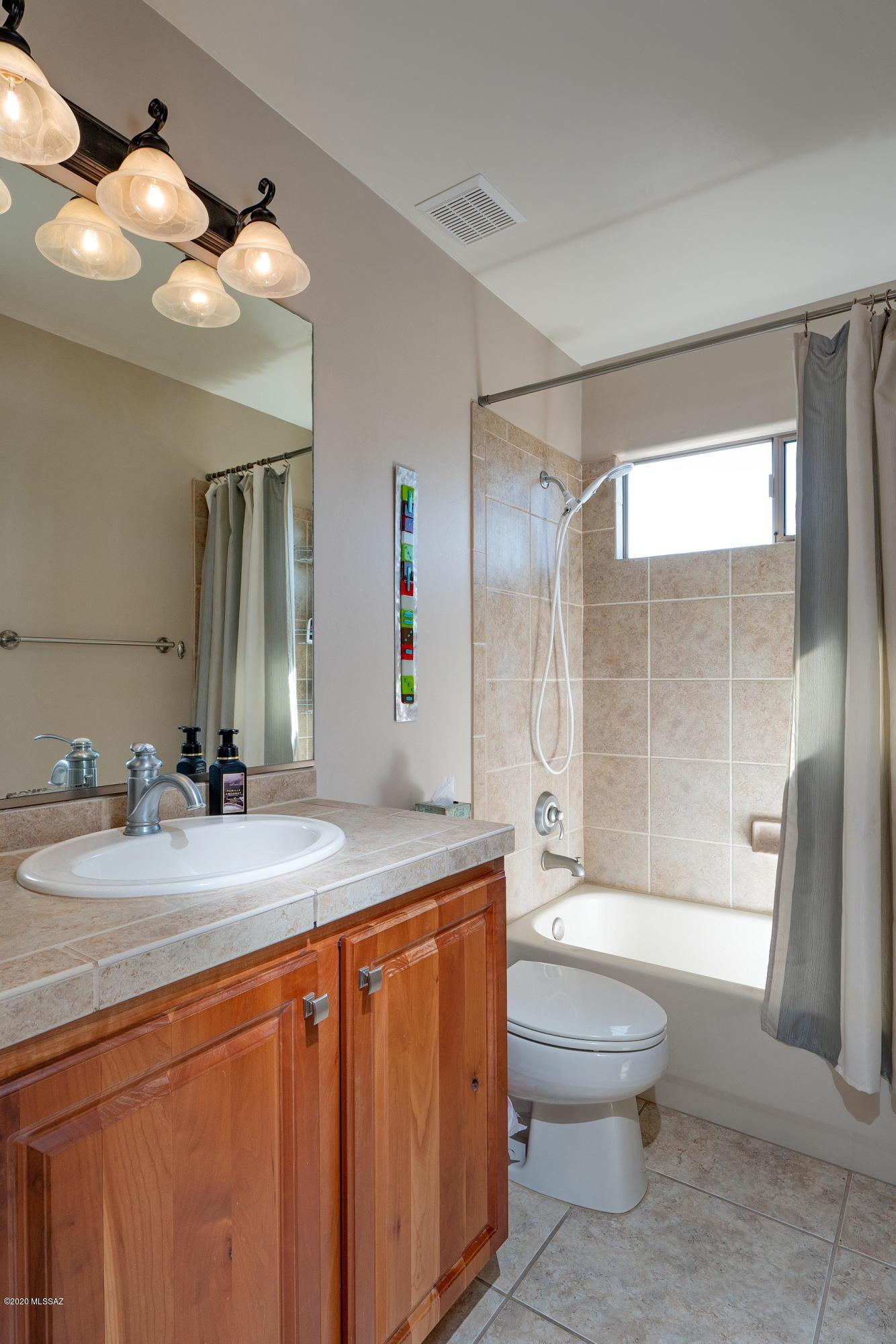 4440 West Crystal Ranch Place Marana, AZ 85658 - Photo 20 of 28 a bathroom with a granite countertop sink toilet a large mirror a shower and bathtub