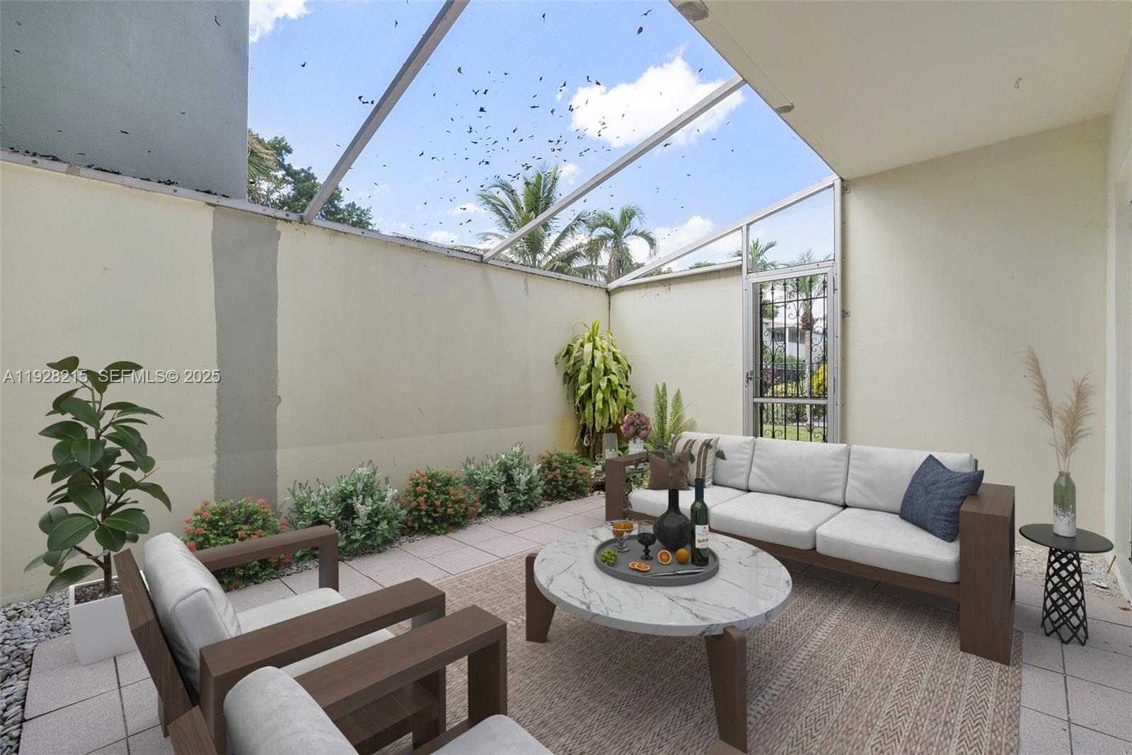5850 Northwest 57th Avenue, Unit 1 Tamarac, FL 33319 - Photo 12 of 56 a living room with furniture and a potted plant
