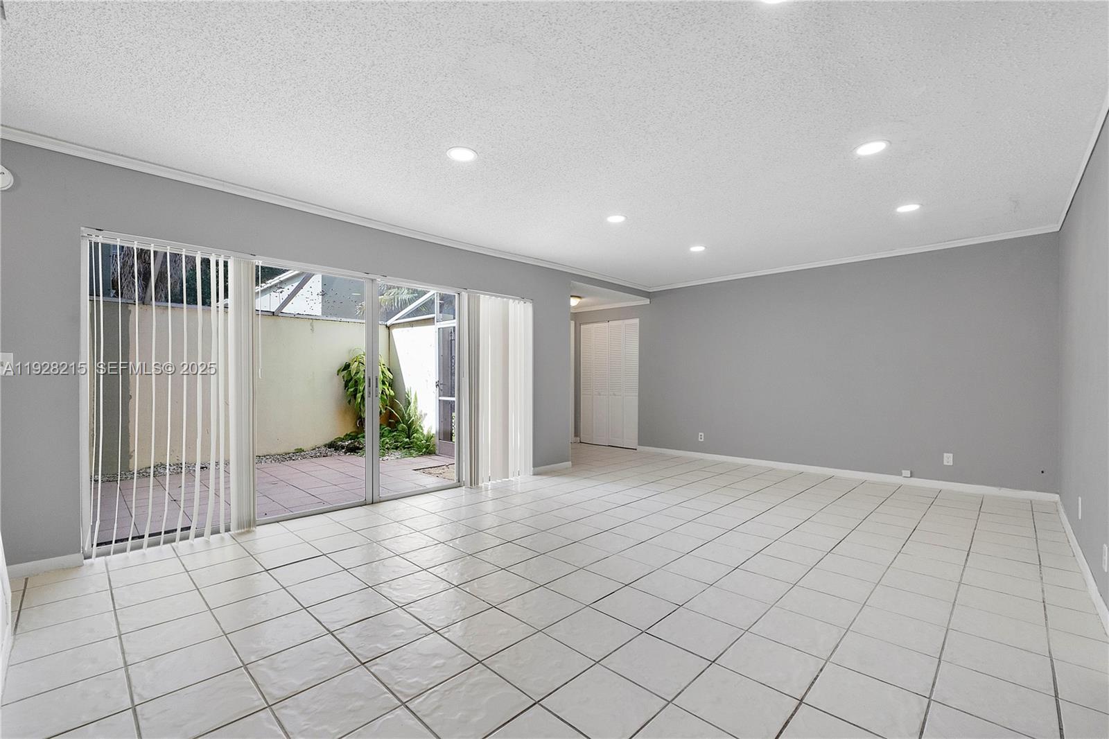5850 Northwest 57th Avenue, Unit 1 Tamarac, FL 33319 - Photo 19 of 56 a view of an empty room and window