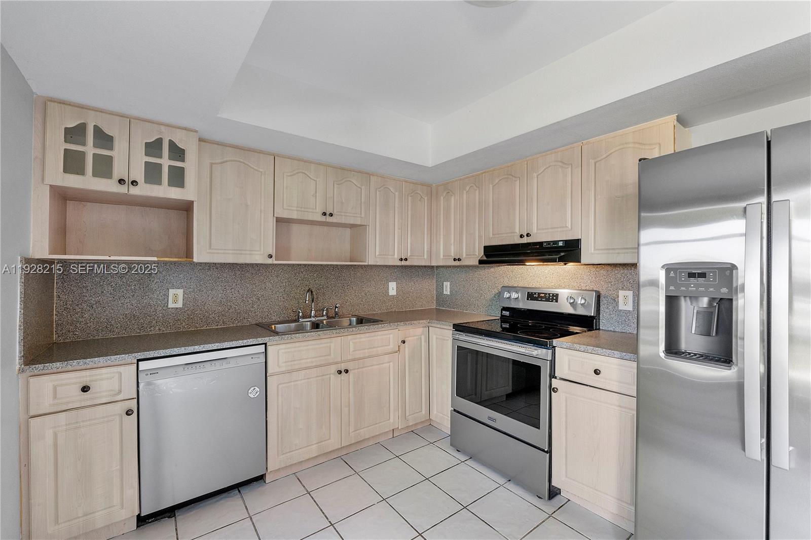 5850 Northwest 57th Avenue, Unit 1 Tamarac, FL 33319 - Photo 27 of 56 a kitchen with white cabinets and white appliances