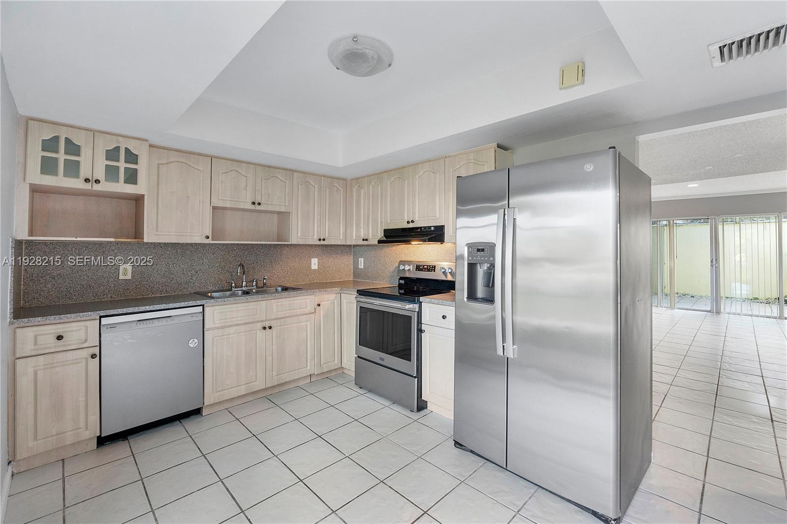 5850 Northwest 57th Avenue, Unit 1 Tamarac, FL 33319 - Photo 29 of 56 a kitchen with cabinets stainless steel appliances and a counter space
