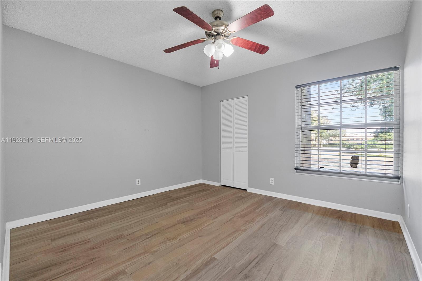 5850 Northwest 57th Avenue, Unit 1 Tamarac, FL 33319 - Photo 31 of 56 wooden floor in an empty room with a window