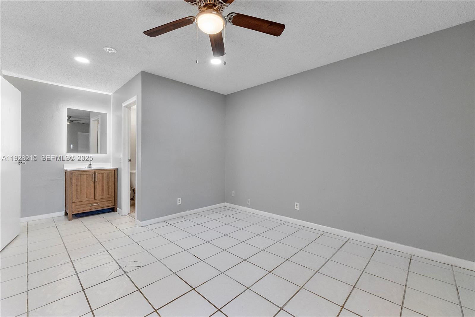 5850 Northwest 57th Avenue, Unit 1 Tamarac, FL 33319 - Photo 35 of 56 a view of an empty room and window
