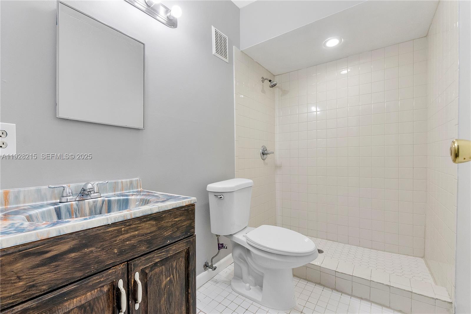 5850 Northwest 57th Avenue, Unit 1 Tamarac, FL 33319 - Photo 37 of 56 a bathroom with a sink a toilet and shower