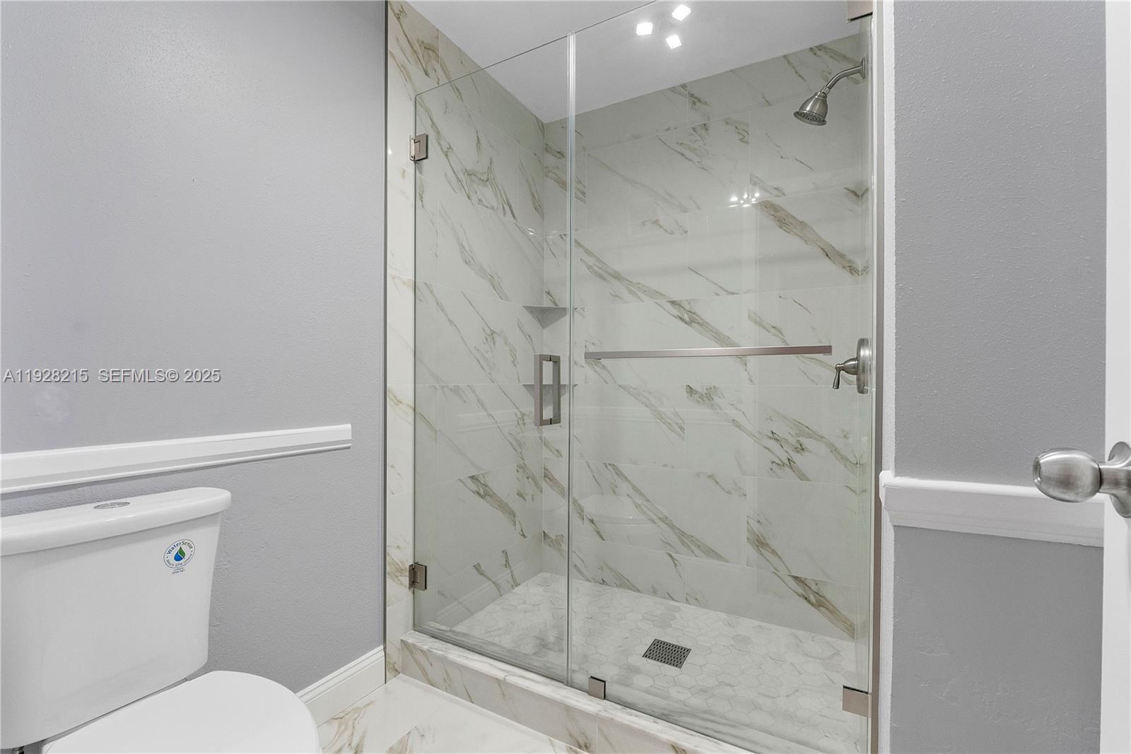 5850 Northwest 57th Avenue, Unit 1 Tamarac, FL 33319 - Photo 40 of 56 a bathroom with a shower and toilet