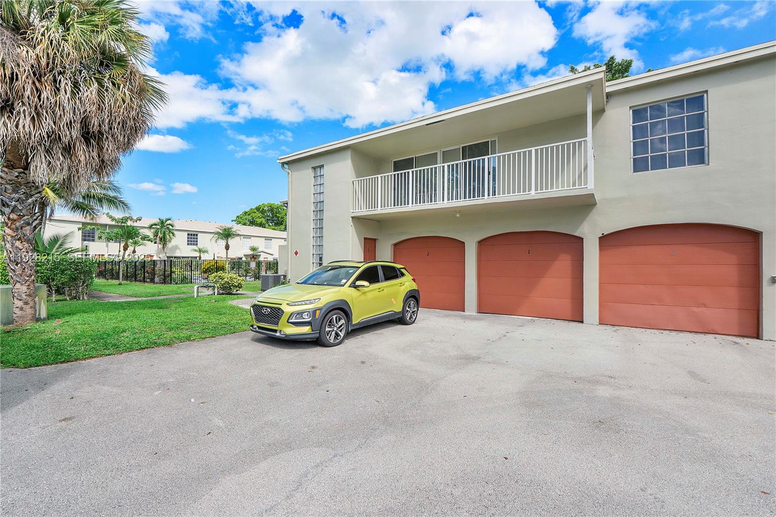 5850 Northwest 57th Avenue, Unit 1 Tamarac, FL 33319 - Photo 54 of 56 a view of garage with a car parked in front of it