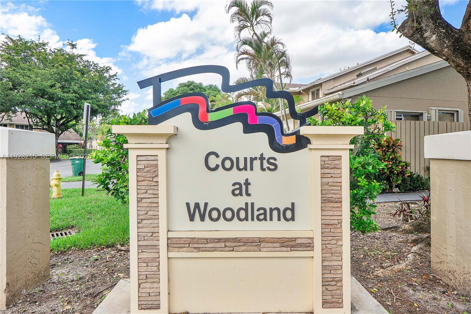 5850 Northwest 57th Avenue, Unit 1 Tamarac, FL 33319 - Photo 56 of 56 a sign that is on the side of the road