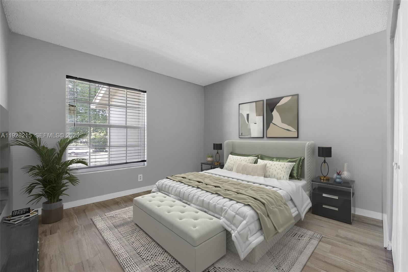 5850 Northwest 57th Avenue, Unit 1 Tamarac, FL 33319 - Photo 6 of 56 a bedroom with a bed and a potted plant