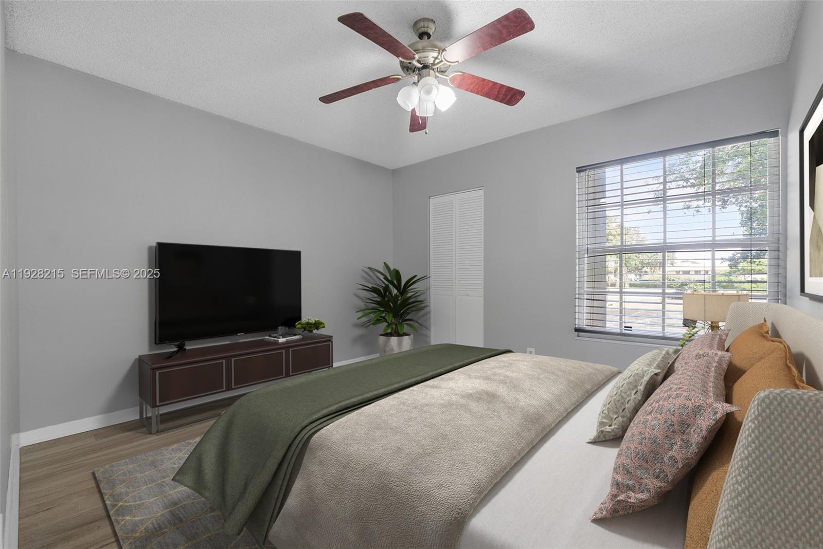 5850 Northwest 57th Avenue, Unit 1 Tamarac, FL 33319 - Photo 8 of 56 a bedroom with a bed and a flat screen tv