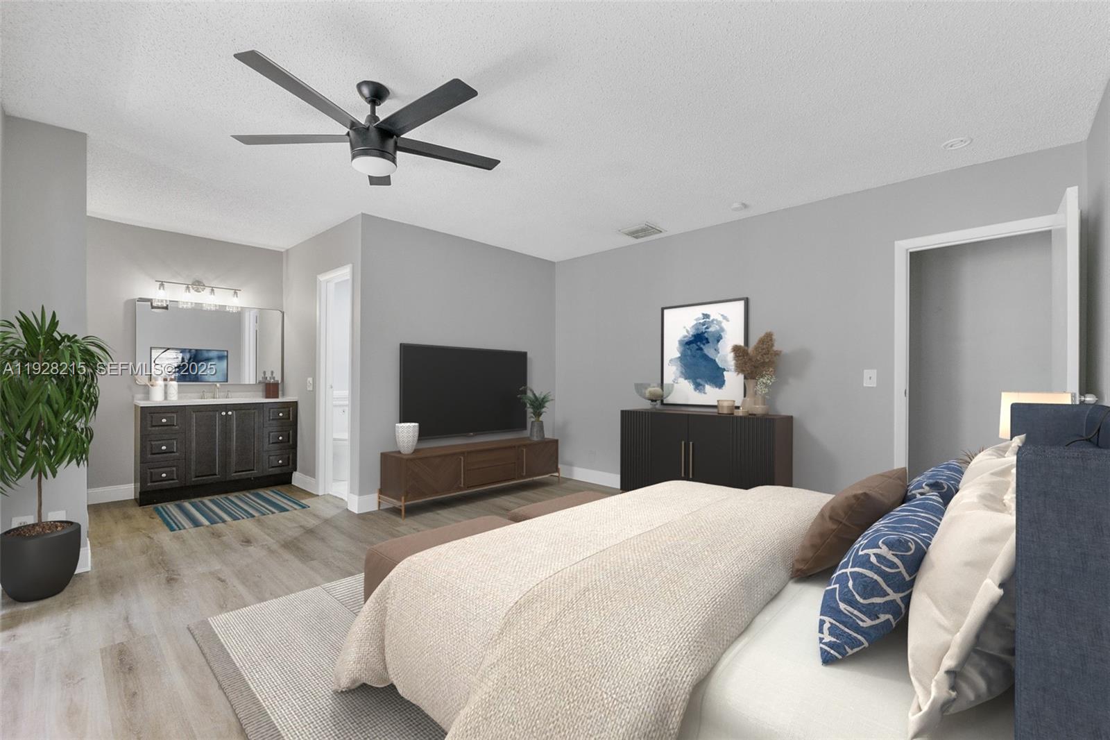 5850 Northwest 57th Avenue, Unit 1 Tamarac, FL 33319 - Photo 9 of 56 a bedroom with a bed and a flat screen tv