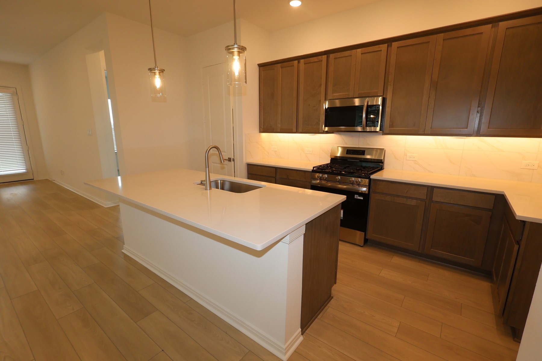 134 Afton June Drive Rosenberg, TX 77471 - Photo 7 of 17 a kitchen with a sink a stove and a microwave