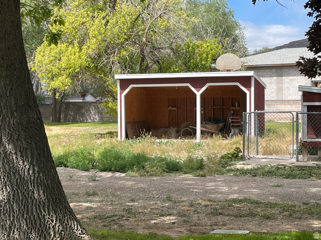 438 East Main Street Elsinore, UT 84724 - Photo 12 of 43 Red-painted outbuilding featuring white trim and two open bays to park the ORV's
