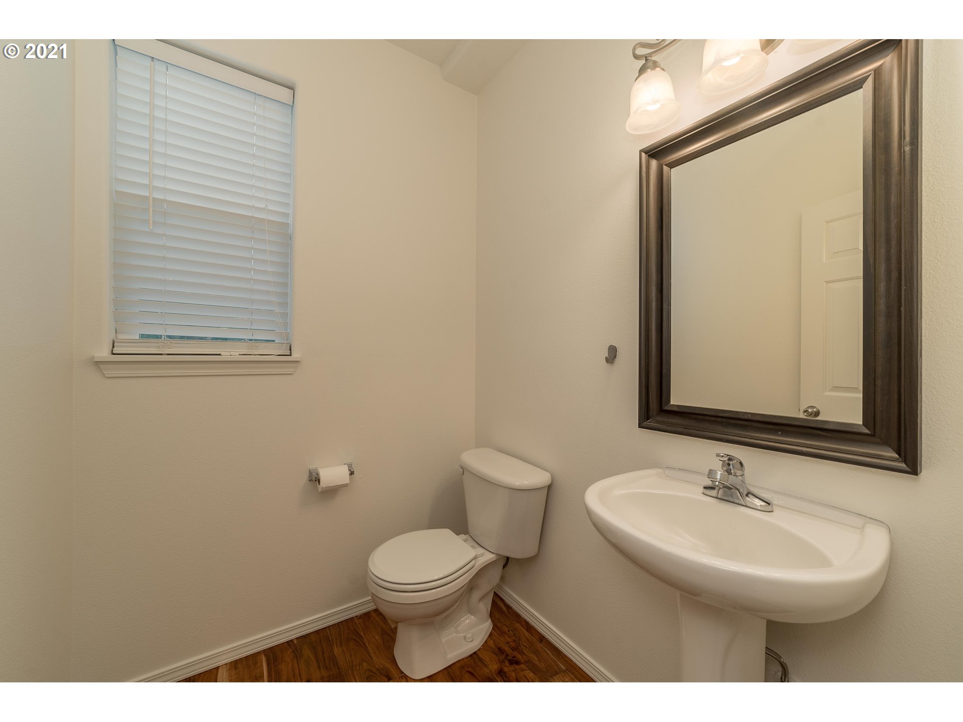 3956 Northwest 12th Avenue Camas, WA 98607 - Photo 11 of 30 a bathroom with a toilet a sink a mirror and a window