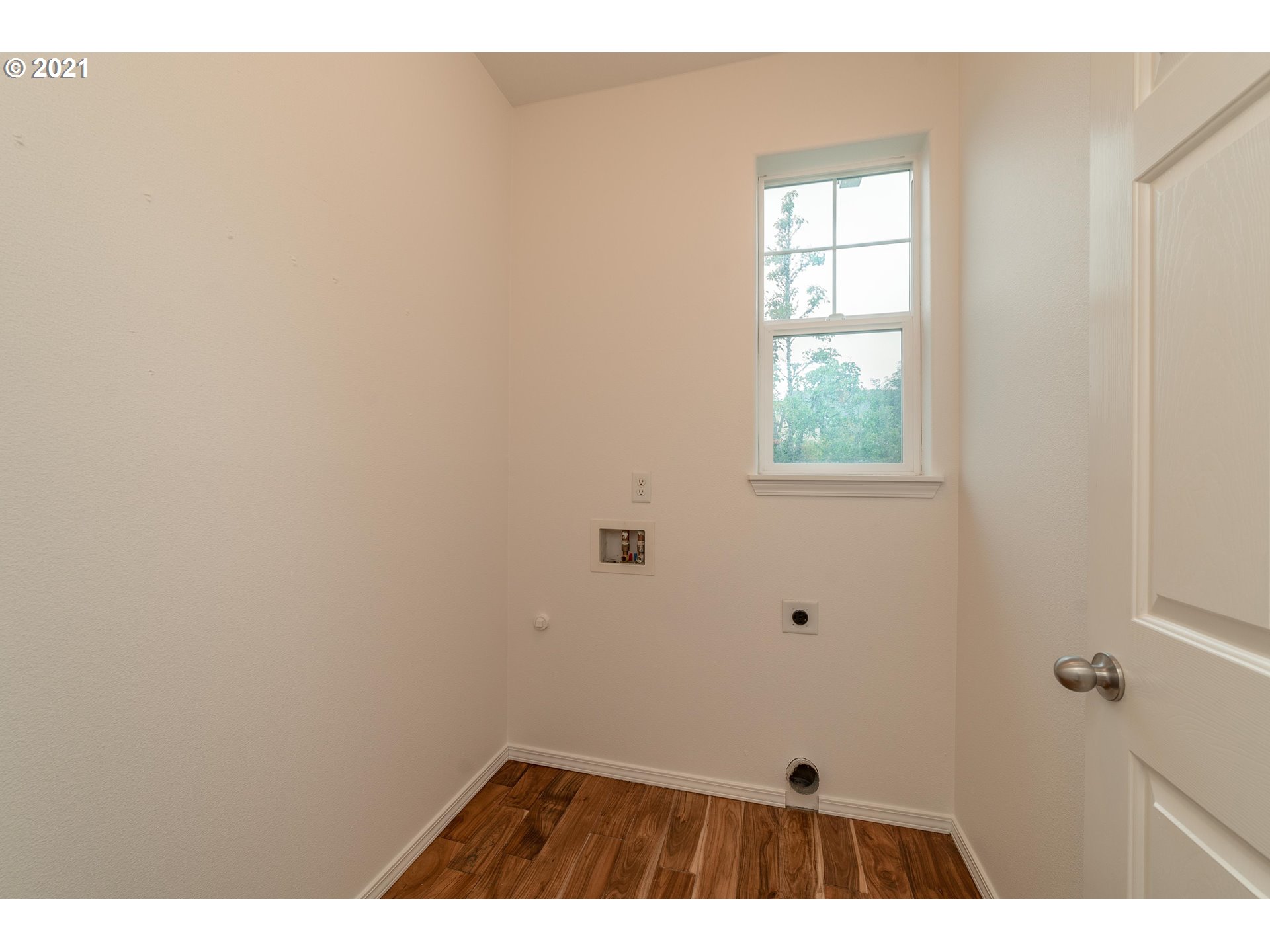 3956 Northwest 12th Avenue Camas, WA 98607 - Photo 12 of 30 a view of an empty room with wooden floor and a window