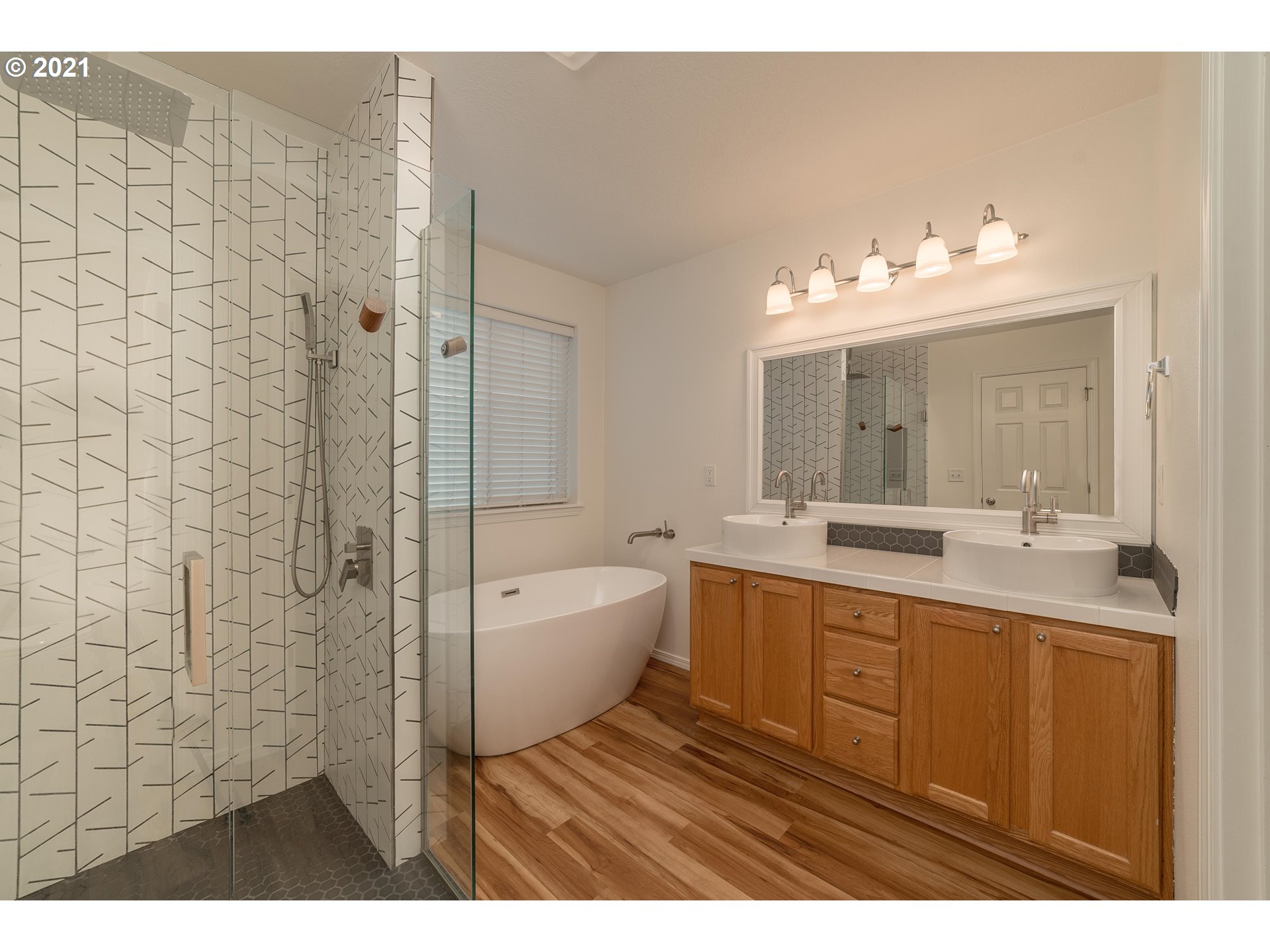 3956 Northwest 12th Avenue Camas, WA 98607 - Photo 16 of 30 a bathroom with a sink a mirror and a bathtub