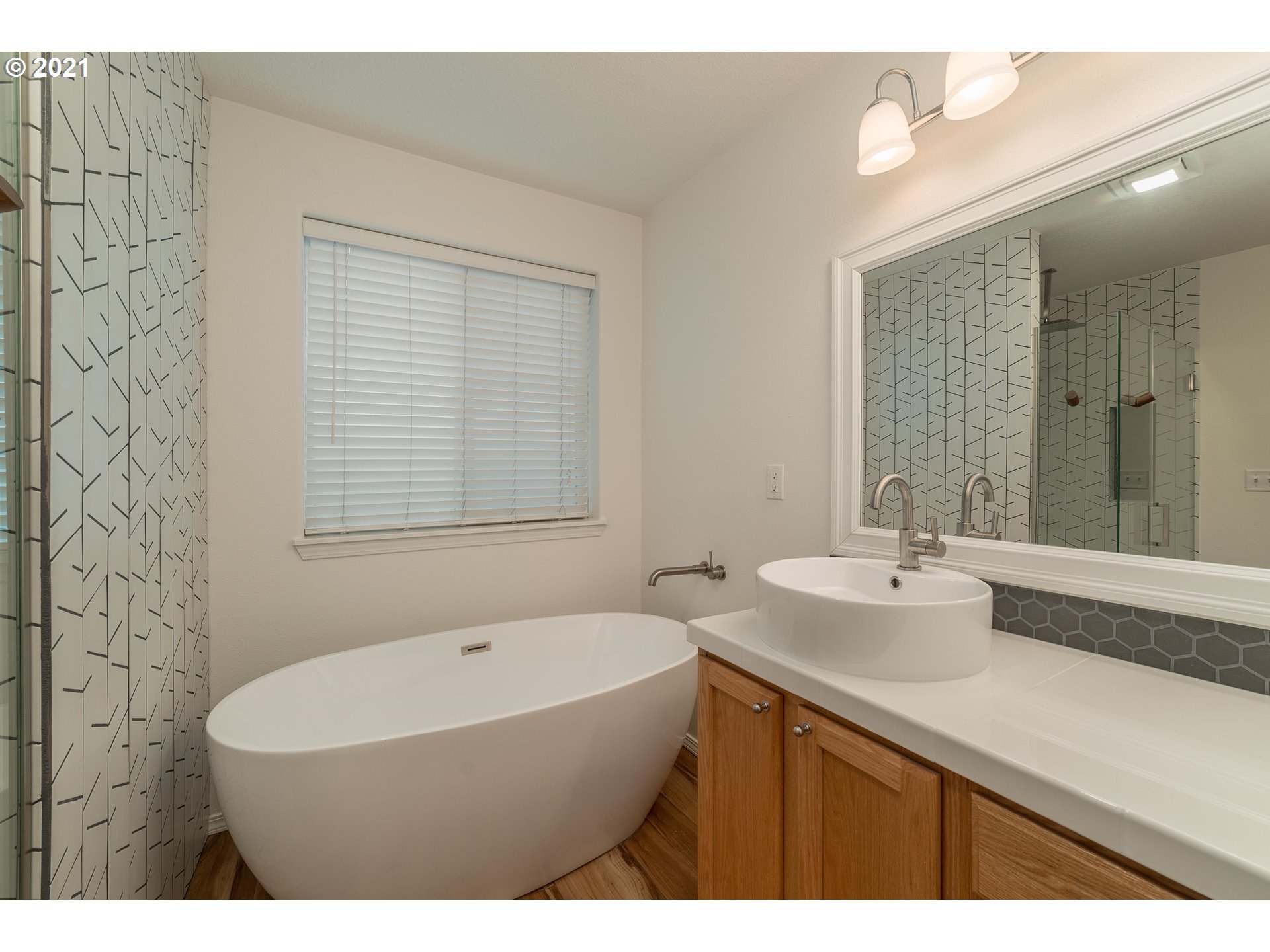 3956 Northwest 12th Avenue Camas, WA 98607 - Photo 18 of 30 a bathroom with a sink a bathtub and a mirror