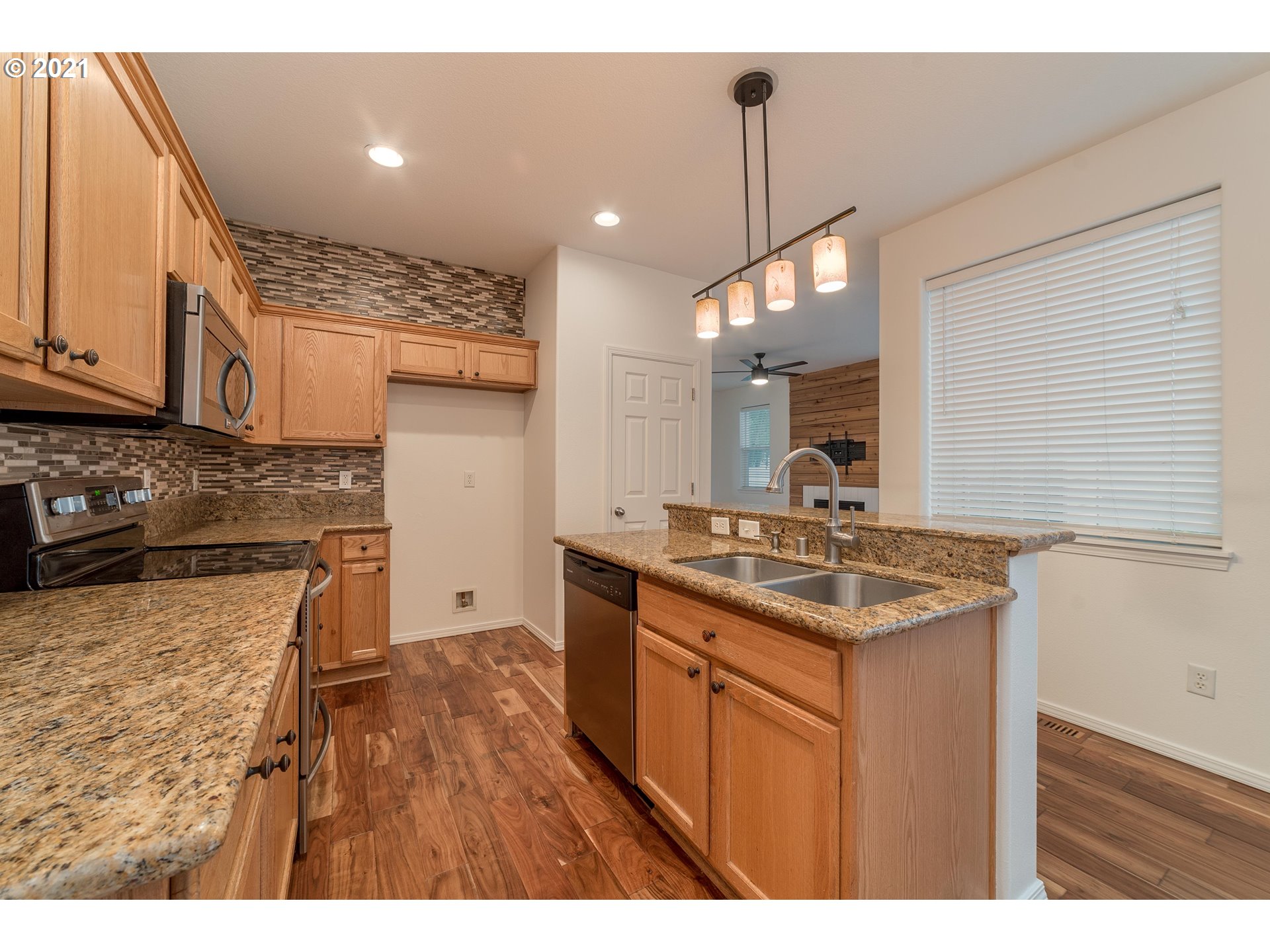 3956 Northwest 12th Avenue Camas, WA 98607 - Photo 9 of 30 a kitchen with a sink stove and cabinets