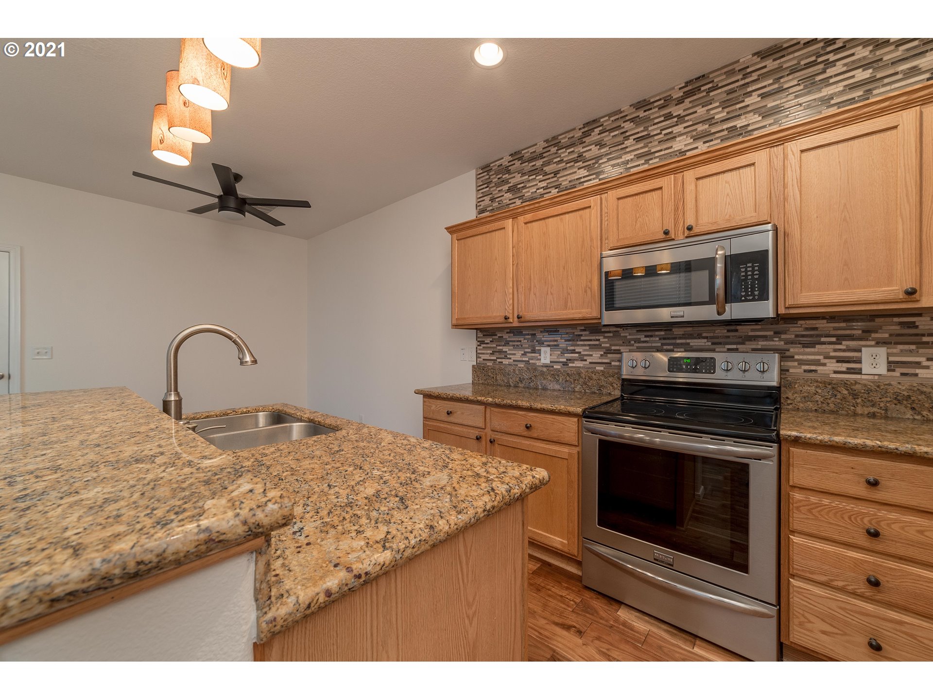 3956 Northwest 12th Avenue Camas, WA 98607 - Photo 10 of 30 a kitchen with stainless steel appliances granite countertop a stove microwave and a sink