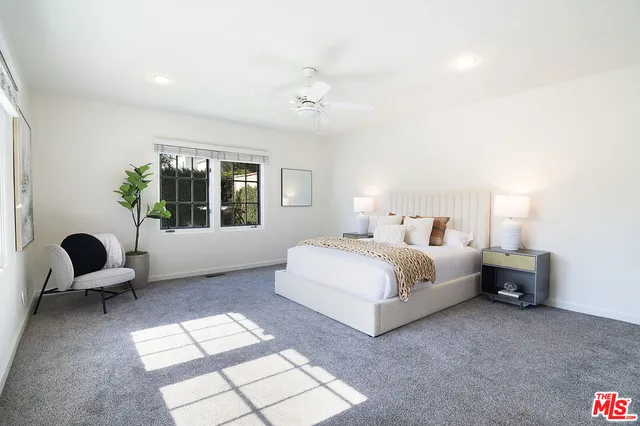 a bedroom with bed and window