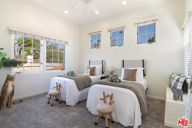 a bed room with two bed and a chair