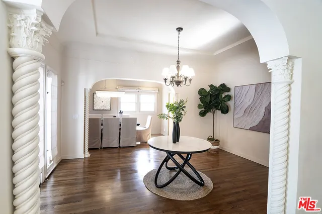a view of a room with furniture and a chandelier