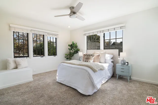 a spacious bedroom with a large bed and a large window