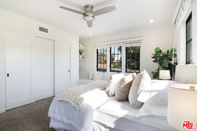 a bedroom with a large bed and a large window